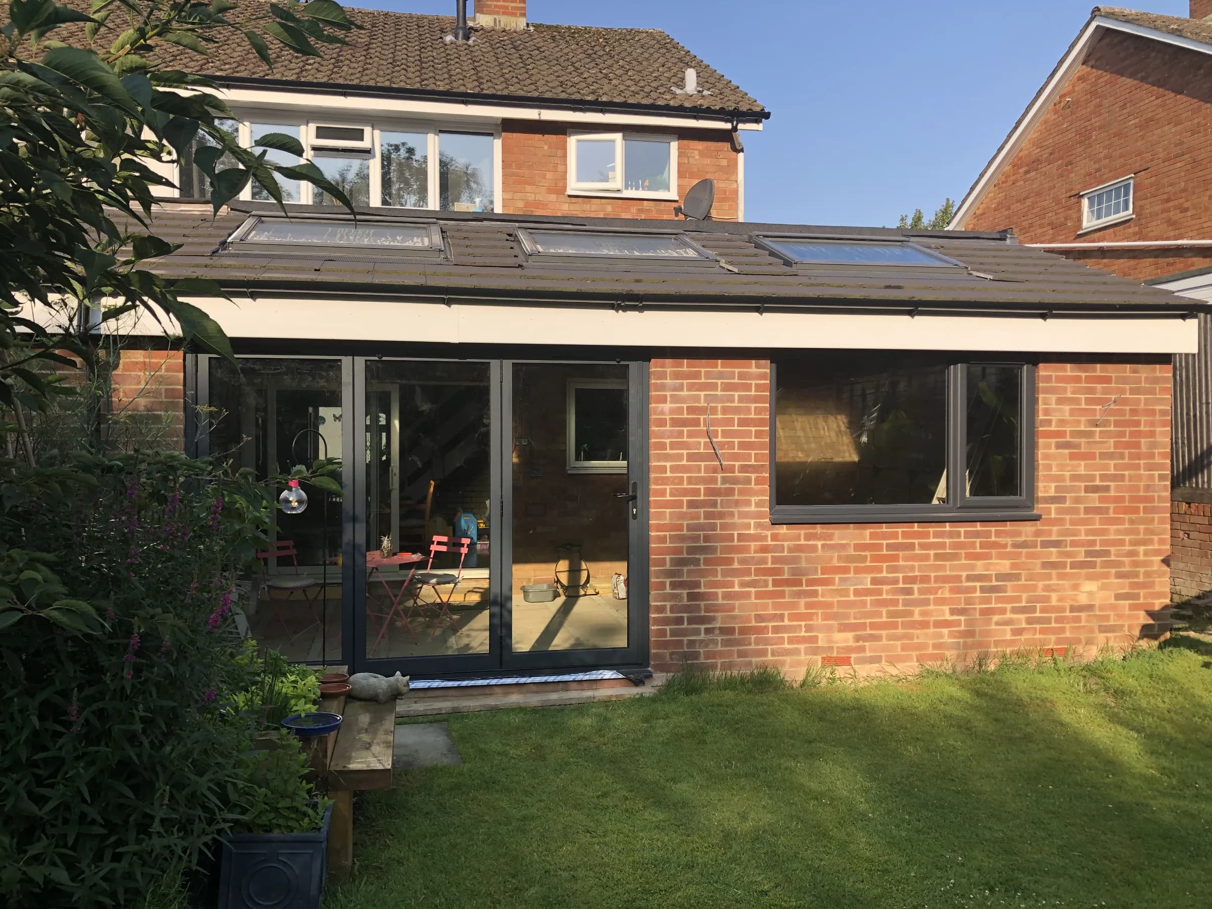 Single-storey rear extension with bi-fold doors and new patio, photo 2