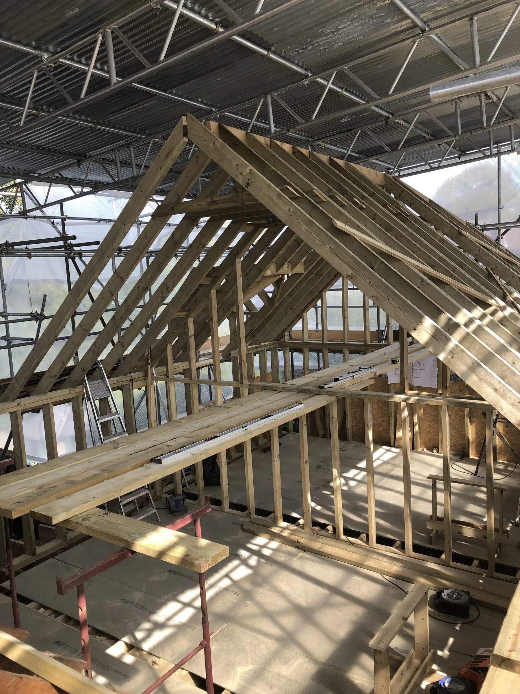 New roof structure and stud walls built under a temporary roof