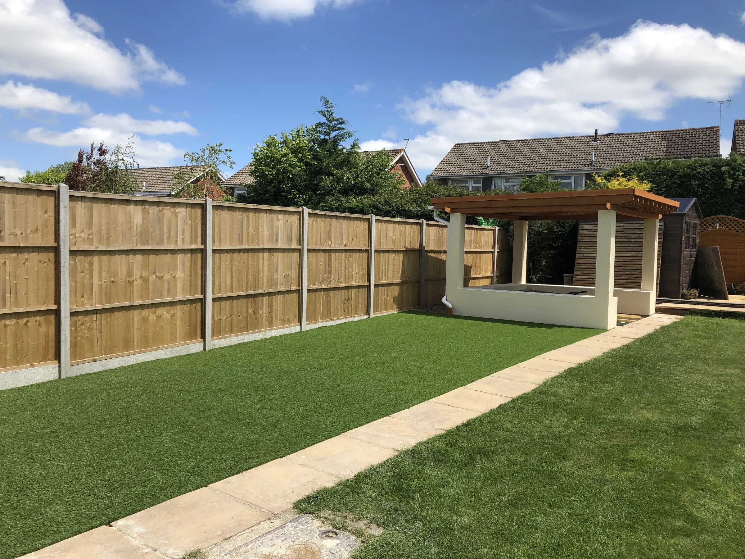 Garden fencing, artificial lawn and covered hot tub shelter
