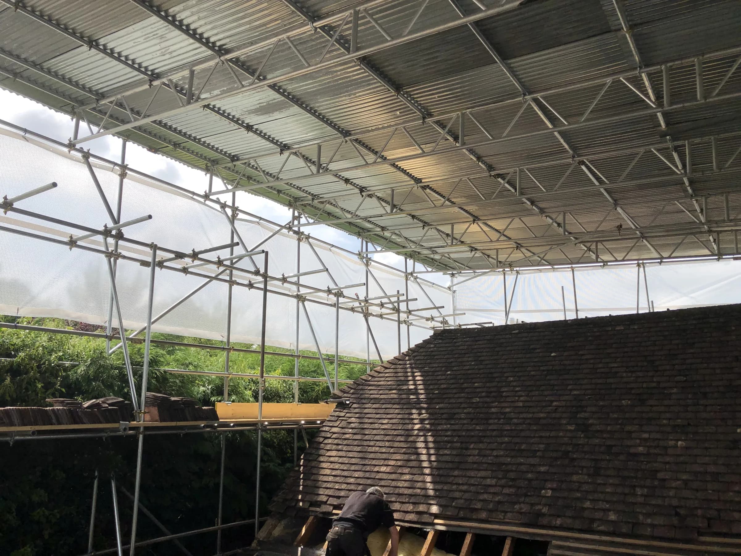 New roof structure and stud walls built under a temporary roof, photo 2
