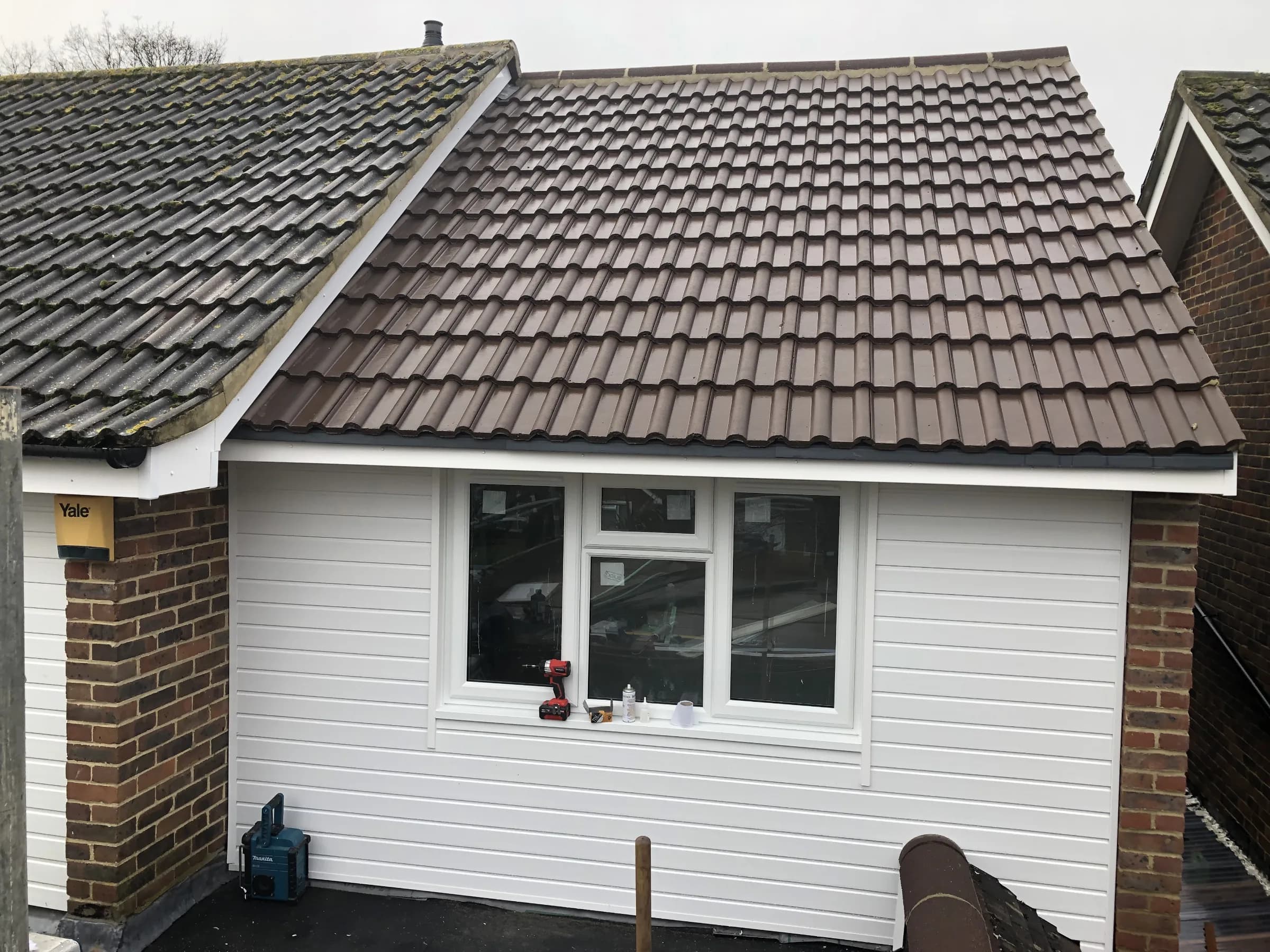 New tiled roof, cladding and window on a single-storey extension